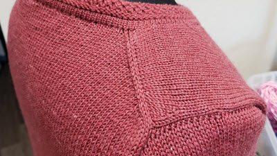 European Shoulder Close-up of a machine-knitted European shoulder showing the distinctive angled seam placement