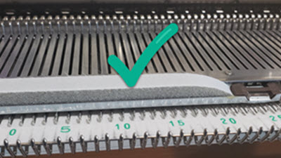 Check your Spongebar Close-up of a new knitting machine spongebar showing intact, firm foam material that properly maintains needle positions during knitting