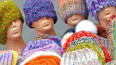 Get Creative and Spread Joy: Donate Hats for Winter A colorful collection of hand-knitted winter hats arranged together, showcasing various patterns and styles for donation to those in need