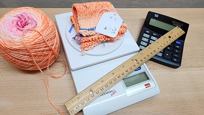 Hats: How much yarn do I need? Knitting supplies: a ball of yarn, ruler, calculator, and a knitted swatch being weighed on a digital food scale