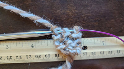 This is NOT a swatch A comically small knitting sample showing just three stitches cast on with about one inch of knitting, demonstrating what not to do when swatching