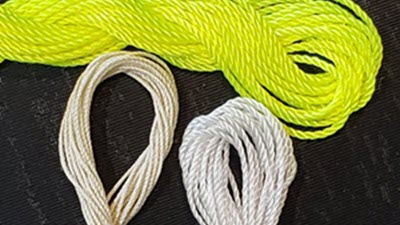 6 Ways to use Ravel Cord Three different types of ravel cord displayed side by side, showing varying thicknesses and materials used for machine knitting cast-on and waste edges