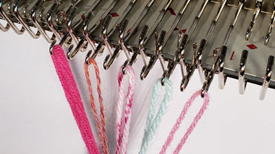 Yarn for Knitting Machines Visual guide showing five yarn weights demonstrated on knitting machine needles for gauge comparison