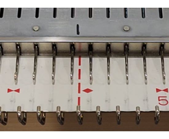 Animated GIF showing a knitting machine needlebed number strip shifting, demonstrating why knitters should mark the true zero point.

