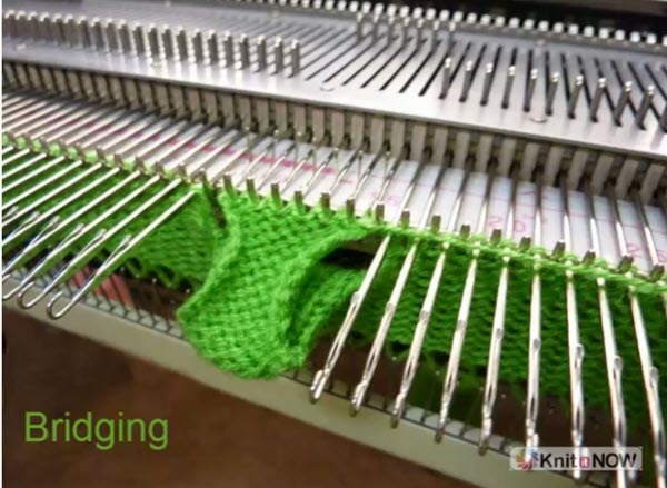 Bridging technique on held stitches in machine knitting