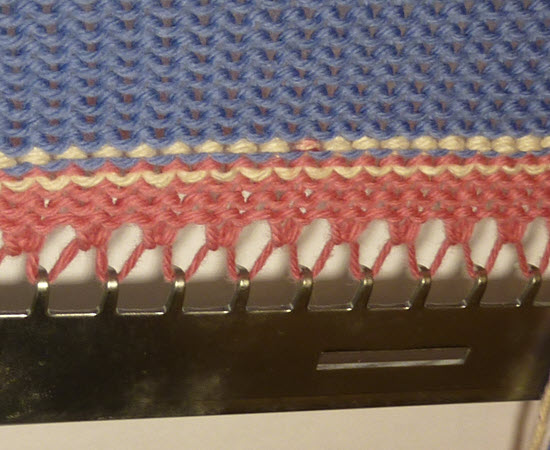 cast-on edge with waste yarn, ravel cord, and weight