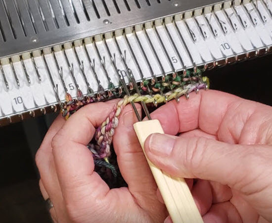 Demonstration of pick up technique in machine knitting