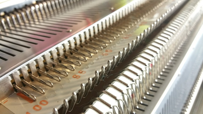 Ribber Attachment on a Knitting Machine Knitting machine with ribber attachment